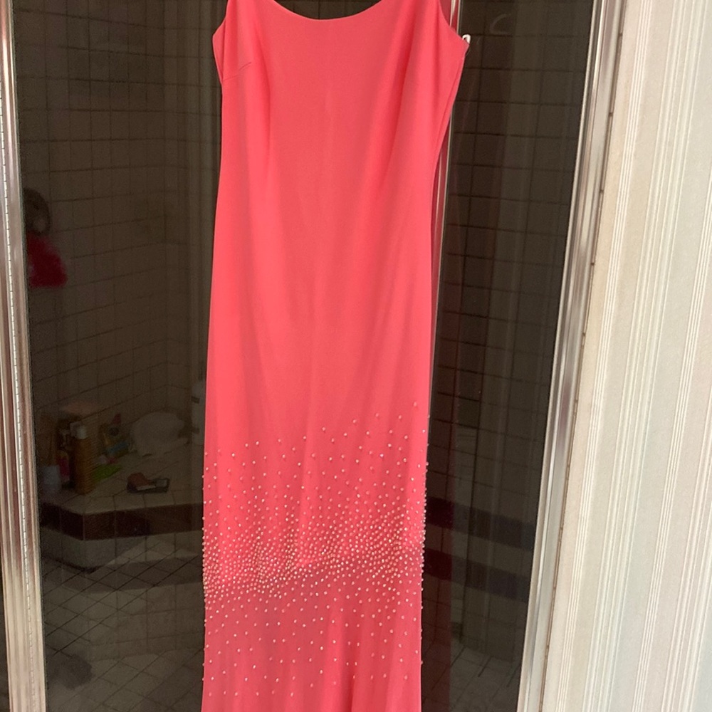 Evening gown coral color with sequins on the bottom half and low back